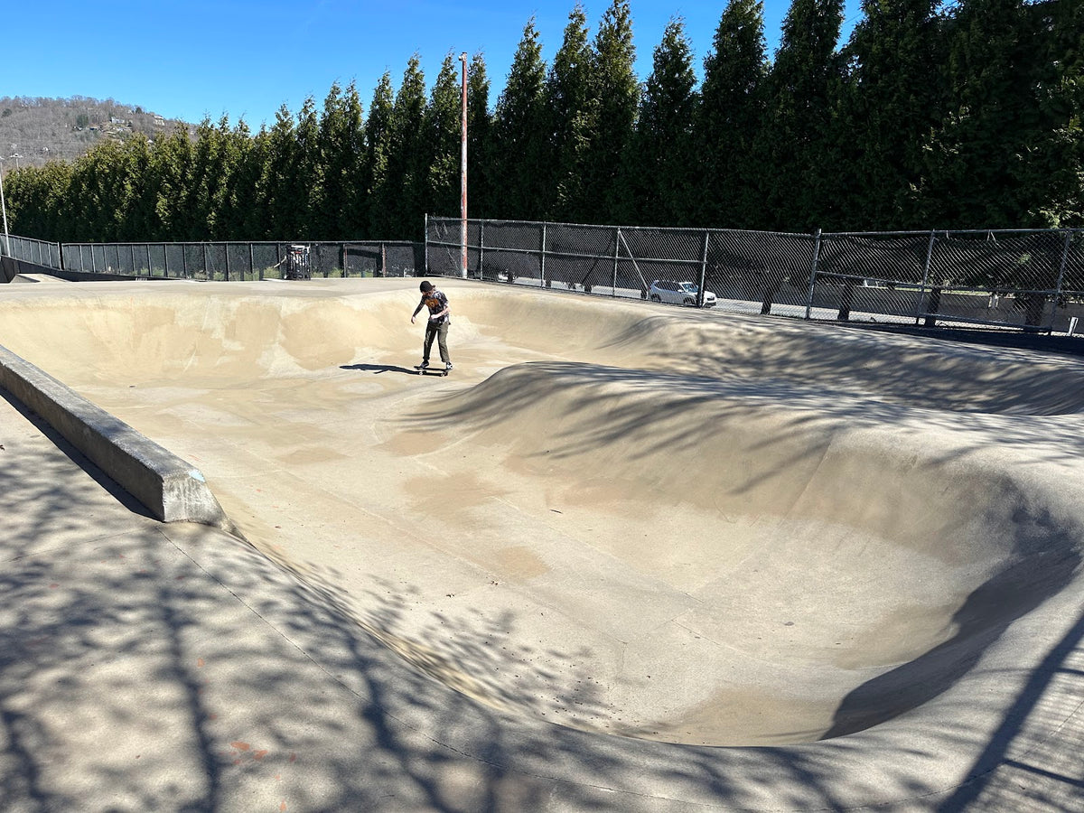 Skater riding the Asheville Skatepark concrete bowl