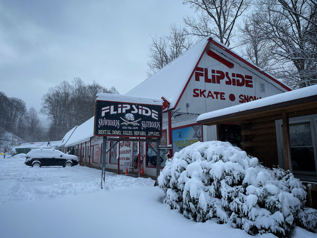 Flipside Boardshop storefront covered in snow in Maggie Valley