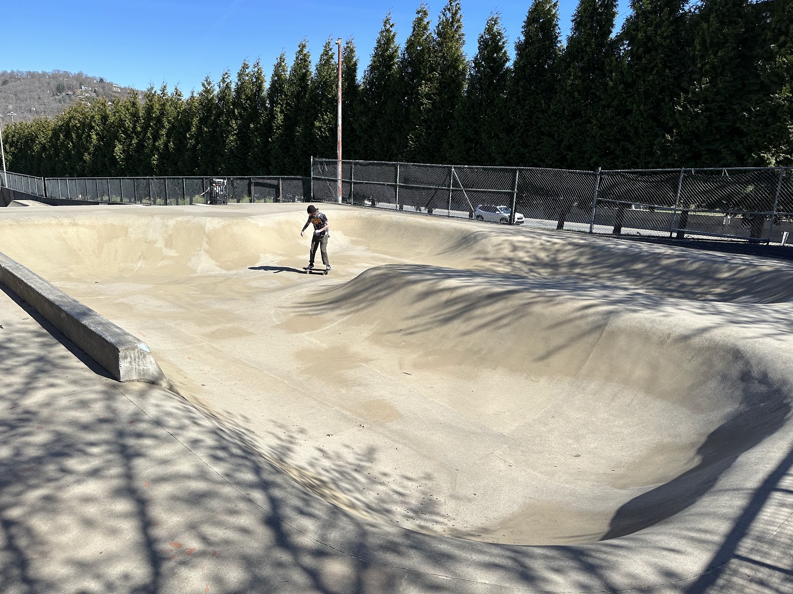 Skater riding the Asheville Skatepark concrete bowl